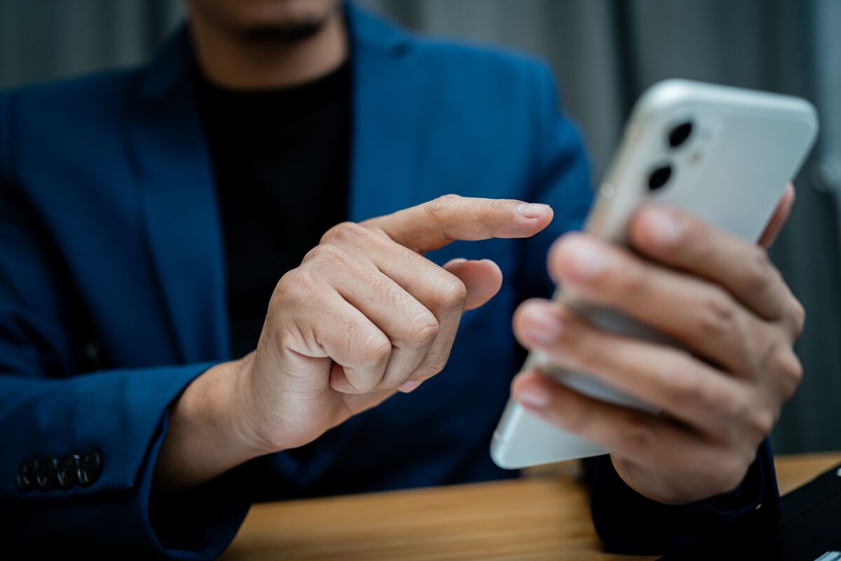 a man dialing on a cellphone